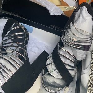 High heeled size 10 sandals Black with silver straps.